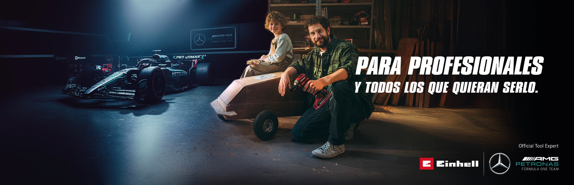Un padre y su hijo en un taller con un coche de jabón casero. Al fondo, un coche de Fórmula 1 del equipo Mercedes-AMG PETRONAS y herramientas Einhell. A la derecha, el texto dice: "Para profesionales y quienes quieren llegar a serlo."