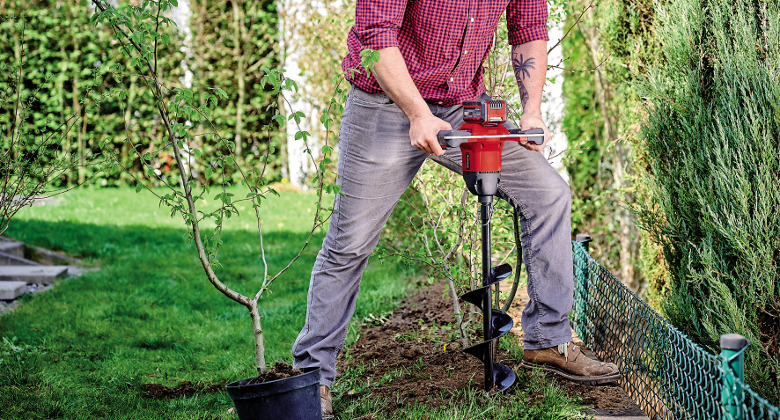 cordless earth auger in use