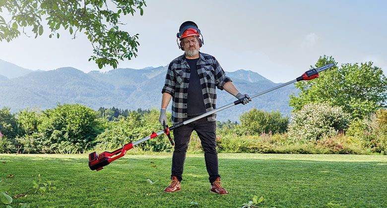 man holding pole saw