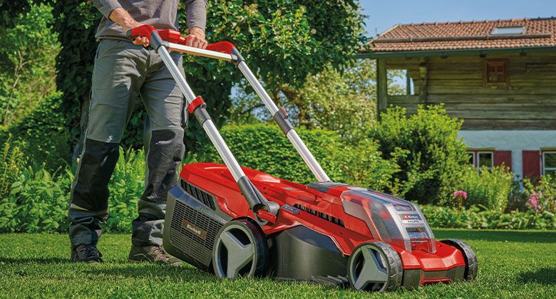 A cordless lawnmower with a large plastic grass catcher box.
