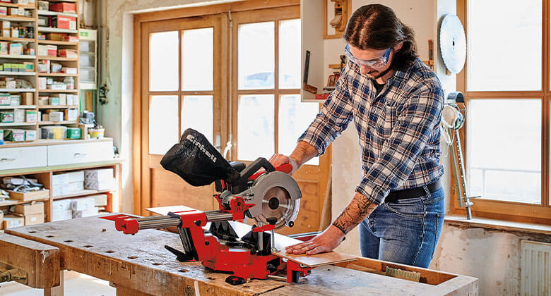 man working with a cordless sliding mitre saw