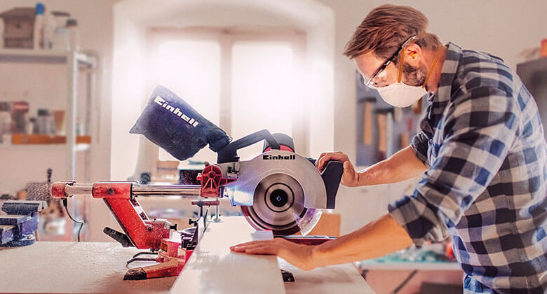 man working with an electric mitre saw