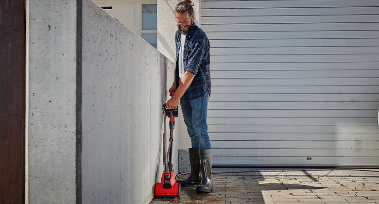 man working with a surface brush