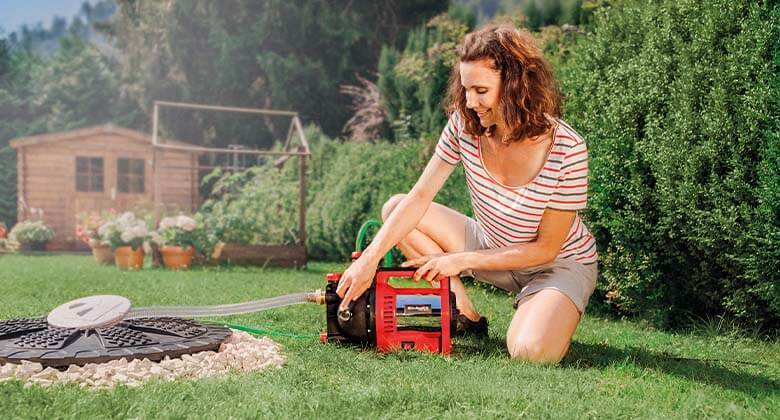 woman working with a garden water pump